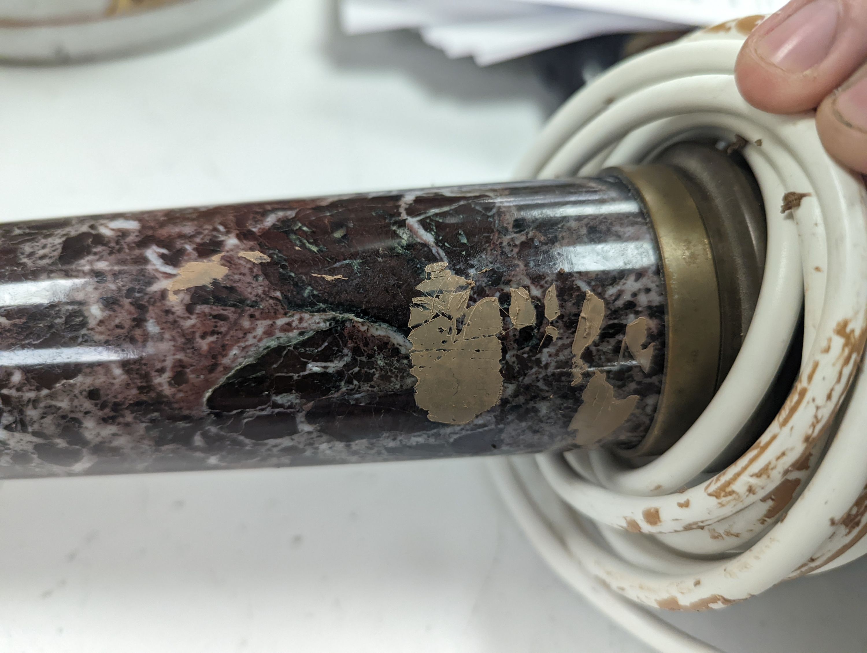 A brass and variegated marble Corinthian column lamp base, 47cms high, not including light fitting.